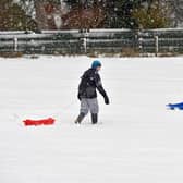 COUPAR ANGUS, UNITED KINGDOM - JANUARY 22:  Children pull sledges through the snow  in Coupar Angus on January 22, 2013 in Coupar Angus, United Kingdom.  (Photo by Jeff J Mitchell/Getty Images)