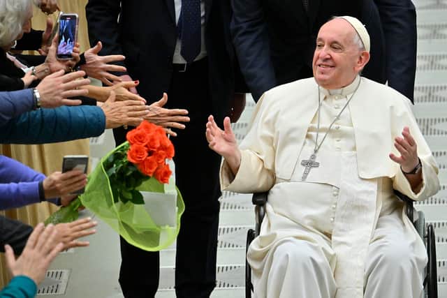 Pope Francis, in a wheelchair, salutes the pilgrims during the weekly general audience in Paul VI hall at the Vatican in December 2022 (Credit: FILIPPO MONTEFORTE/AFP via Getty Images)