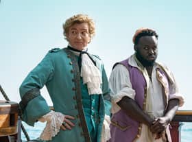 Rhys Darby as Stede Bonnet and Samson Kayo as Oluwande in Our Flag Means Death (Credit: BBC/Warner Bros. Entertainment Inc/Jake Giles Netter)