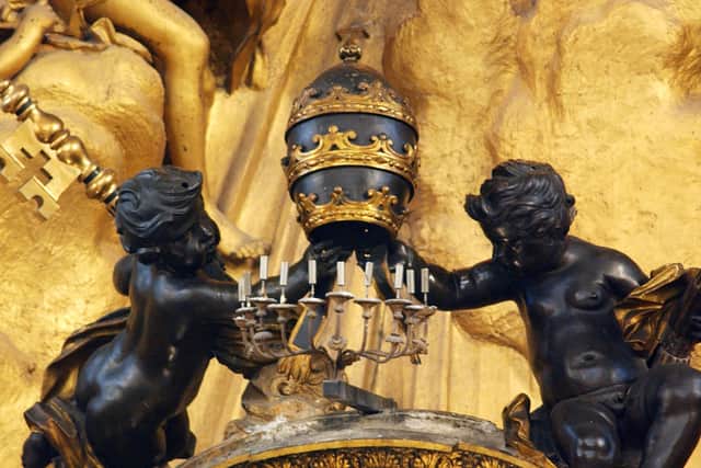 A sculpture showing two angels holding the Pope’s tiara and the St. Peter’s keys (Getty Images)