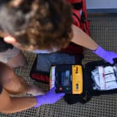 RNLI lifeguard supervisor Sam Woodard checks a defibrillator as he prepares a lifeguard station on the beach at Viking Bay in Broadstairs, south-east England, in May 2020, during the Covid-19 pandemic (Photo: BEN STANSALL/AFP via Getty Images)
