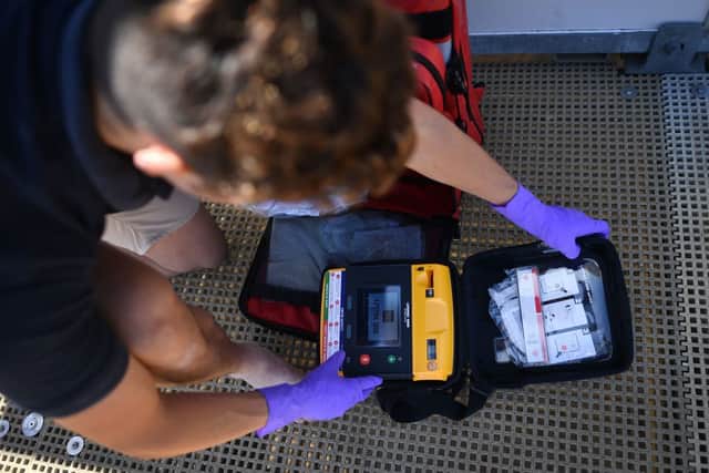 RNLI lifeguard supervisor Sam Woodard checks a defibrillator as he prepares a lifeguard station on the beach at Viking Bay in Broadstairs, south-east England, in May 2020, during the Covid-19 pandemic (Photo: BEN STANSALL/AFP via Getty Images)