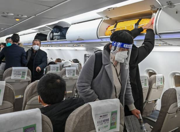 <p>A passenger wearing a face shield and mask boards a domestic flight at Shanghai Pudong International Airport in Shanghai on January 3, 2023. Credit: Getty Images</p>