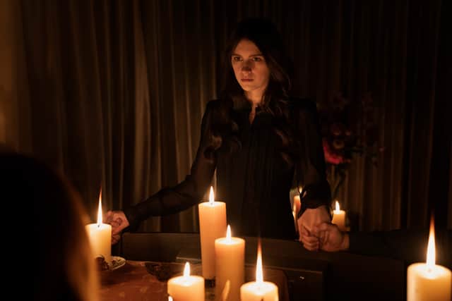 Nell Tiger Free as Leanne Grayson in Servant, surrounded by lit candles (Credit: Apple TV+)