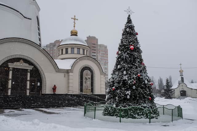 A Christmas tree stands outside the Holy Transfiguration Cathedral, which changed its affiliation from the Russian Orthodox Church to the Orthodox Church of Ukraine. (Photo by Brendan Hoffman/Getty Images)