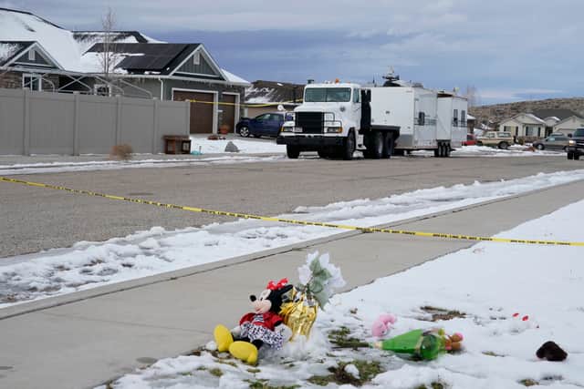 ENOCH, UT - JANUARY 05: The wind blows flowers, part of a makeshift memorial as a police crime scene trailer sits outside the home of Michael Haight on January 5, 2023 in Enoch, Utah. Haight, who was 42, is accused of killing his wife, mother-in-law and his five kids that range in ages from 17 to 4 years old with a gun. The police say there are no additional suspects and the community is not in further danger. (Photo by George Frey/Getty Images)