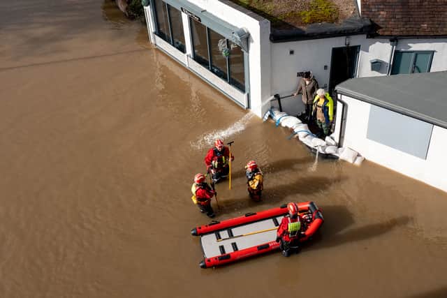 BEWDLEY, WORCESTERSHIRE - FEBRUARY 23:  Personnel from the Severn Area Rescue Association (SARA) wade through flood water in Bewdley to check on the welfare of residents after the River Severn breached defences on February 23, 2022 in Bewdley, Worcestershire. Police declared a major incident here over concerns the River Severn could breach its flood barriers. England has been hit by three named storms in a week's time, most recently Storm Franklin. (Photo by Christopher Furlong/Getty Images)