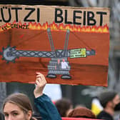A demontrator holds a sign against the demolition of the village of Luetzerath at the Garzweiler open-cast lignite mine during a demonstration before the party congress of the Greens at the World Conference Center in Bonn, western Germany on October 14, 2022. - The first party conference of the Greens to be held “in person” in three years, will take place on 15-16 October, and will focus in particular on nuclear power plant lifespans and the planned support in the face of rising energy prices. (Photo by Ina FASSBENDER / AFP) (Photo by INA FASSBENDER/AFP via Getty Images)