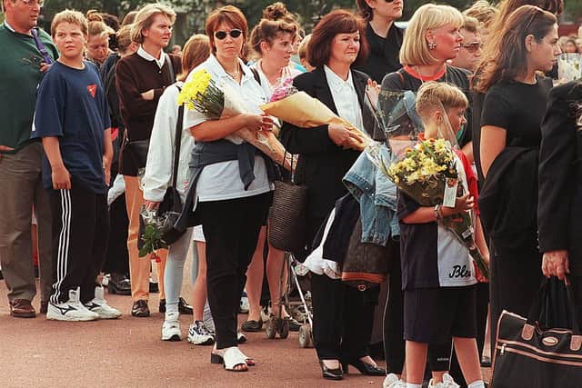 People queue up to leave flowers at Buckingham Palace after Prince Diana’s death in 1997. Credit: MARTYN HAYHOW/AFP via Getty Images