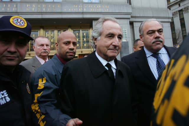 Bernard Madoff (C) walks out from Federal Court after a bail hearing in Manhattan January 5, 2009 in New York City (Photo by Hiroko Masuike/Getty Images)