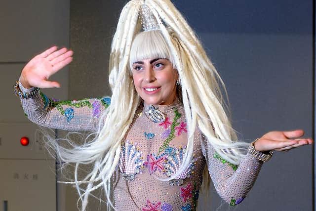 US music star Lady Gaga waves upon her arrival at the Narita International airport in Narita, Chiba prefecture on August 12, 2014. Gaga is set to play two nights at the Chiba Marine Stadium in Tokyo on August 13 and 14 before heading to Seoul to perform at the Olympic Stadium on August 16. AFP PHOTO / TOSHIFUMI KITAMURA (Photo credit: TOSHIFUMI KITAMURA/AFP via Getty Images)