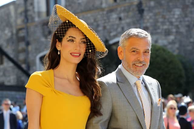 Amal Clooney and George Clooney arrive at St George's Chapel at Windsor Castle before the wedding of Prince Harry to Meghan Markle on May 19, 2018 in Windsor, England. (Photo by Gareth Fuller - WPA Pool/Getty Images)