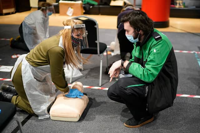 Volunteers conduct CPR training by St John Ambulance instructors during their course to administer Covid-19 vaccines at Manchester United Football Club on January 30, 2021 in Manchester, England (Photo by Christopher Furlong/Getty Images)