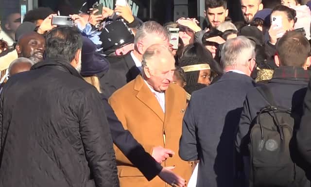 Close-protection officers ushering King Charles III away after he was egged in Luton. Credit: PA