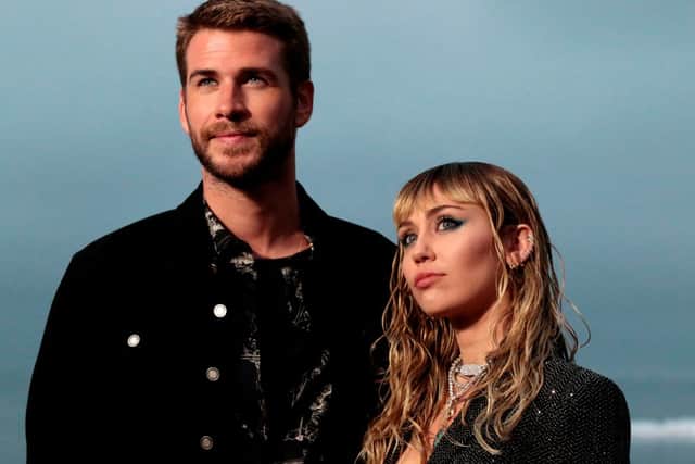 Back in the days of a loving couple... US singer Miley Cyrus and husband Australian actor Liam Hemsworth arrive for the Saint Laurent Men's Spring-Summer 2020 runway show in Malibu, California, on June 6, 2019. (Photo by Kyle GRILLOT / AFP) (Photo credit: KYLE GRILLOT/AFP via Getty Images)