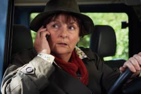 Brenda Blethyn as DCI Vera Stanhope in Vera, taking a phone call while sitting in a car (Credit: ITV)