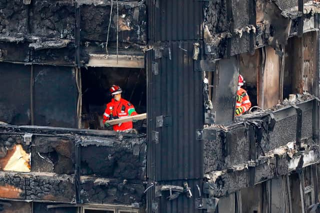 Members of the emergency services work on the middle floors of the charred remains of the Grenfell Tower block (Photo: AFP via Getty Images)