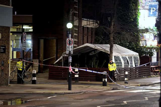 Police near to the scene of a suspected drive-by shooting in Phoenix Road, next to Euston station in north London, where three women, aged 48, 54 and 41 along with a seven-year-old girl have been injured near a church where a funeral was taking place. Picture date: Saturday January 14, 2023.