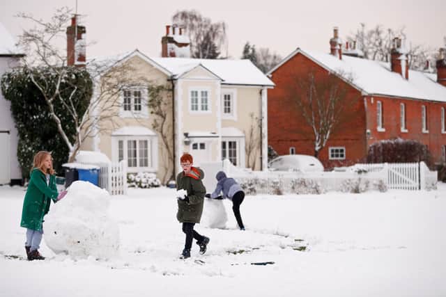 Children play in the snow in Hartley Wintney, in Hampshire, 40 miles west of London, on February 1, 2019. - Snowfall and icy conditions were expected Friday to cause travel disruption after temperatures overnight reached as low as minus 15.4C. An amber snow warning has been issued for an area west of London including parts of Oxfordshire, Hampshire and Buckinghamshire, after as much as 14cm of snow fell on south-west England. (Photo by Adrian DENNIS / AFP)        (Photo credit should read ADRIAN DENNIS/AFP via Getty Images)
