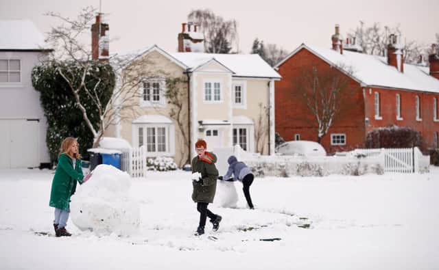Children play in the snow in Hartley Wintney, in Hampshire, 40 miles west of London, on February 1, 2019. - Snowfall and icy conditions were expected Friday to cause travel disruption after temperatures overnight reached as low as minus 15.4C. An amber snow warning has been issued for an area west of London including parts of Oxfordshire, Hampshire and Buckinghamshire, after as much as 14cm of snow fell on south-west England. (Photo by Adrian DENNIS / AFP)        (Photo credit should read ADRIAN DENNIS/AFP via Getty Images)