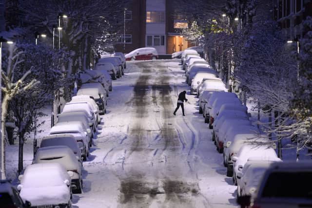 A man walks up a snow-covered road in London, England. (Photo by Leon Neal/Getty Images)