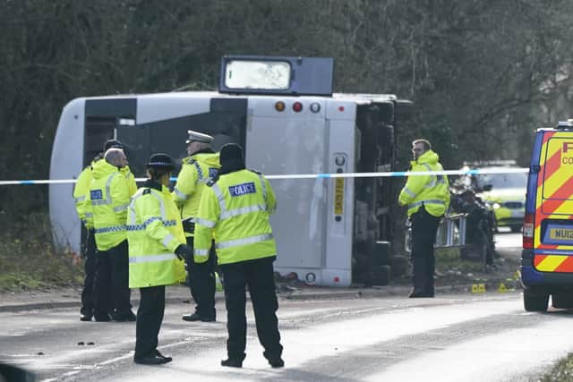 Police at the scene on the A39 Quantock Road in Bridgwater after a double-decker bus overturned in a crash involving a motorcycle. Picture date: Tuesday January 17, 2023. Credit: PA