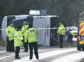 Police at the scene on the A39 Quantock Road in Bridgwater after a double-decker bus overturned in a crash involving a motorcycle. Picture date: Tuesday January 17, 2023. Credit: PA