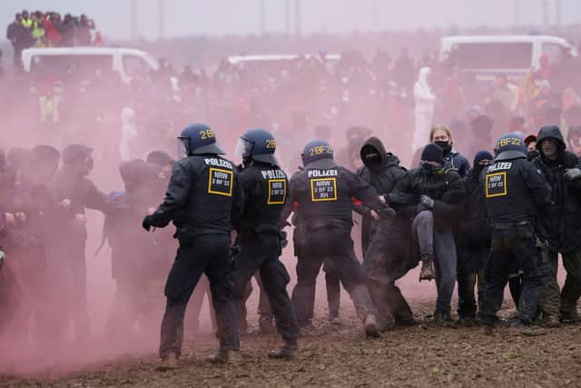 Police in riot gear scuffle with protesters during confrontations near the settlement of Luetzerath on January 14, 2023 near Erkelenz, Germany. Credit: Getty Images