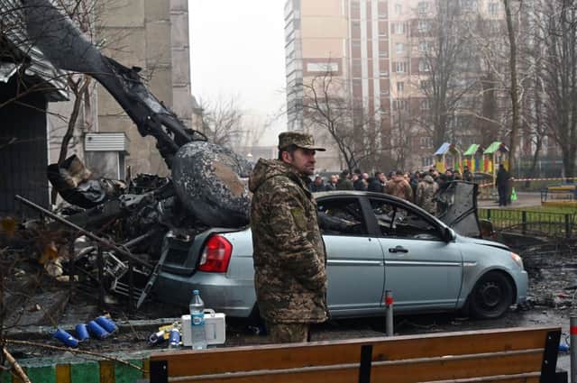 A soldier stands at the site where a helicopter crashed near a kindergarten outside the capital Kyiv, killing Sixteen people, including two children and Ukrainian interior minister. Credit:  SERGEI SUPINSKY/AFP via Getty Images