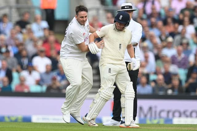 Pitch invader, YouTuber Daniel Jarvis, known as ‘Jarvo 69’ collides whith England’s Jonny Bairstow (R) as he delays play on the second day of the fourth cricket Test match between England and India at the Oval cricket ground in London on September 3, 2021 (Photo by DANIEL LEAL/AFP via Getty Images)