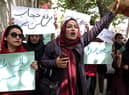 Members of Afghanistan’s Powerful Women Movement, take part in a protest in Kabul, chanting “burqa is not my hijab” after the Taliban’s order for women to cover fully in public. Credit: Getty Images
