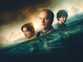 A promotional image for The Catch, depicting Poppy Gilbert as Abby Collier, Jason Watkins as Ed Collier, and Aneurin Barnard as Ryan Wilson. They’re being subsumed by waves. (Credit: Channel 5)