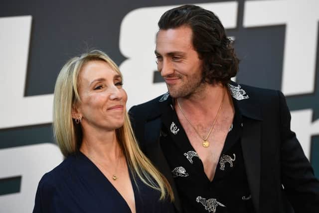 British actor Aaron Taylor-Johnson (R), poses for a picture with his wife British filmmaker Sam Taylor-Johnson during a preview of the film (Bullet Train) in Paris on July 18, 2022 (Photo by CHRISTOPHE ARCHAMBAULT/AFP via Getty Images)