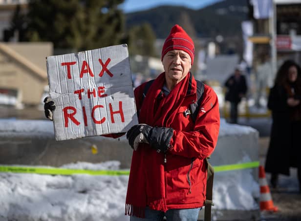 <p>Phil White protests at the World Economic Forum in Davos (AFP via Getty Images)</p>