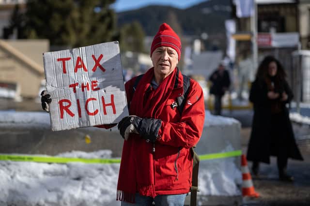 Phil White protests at the World Economic Forum in Davos (AFP via Getty Images)