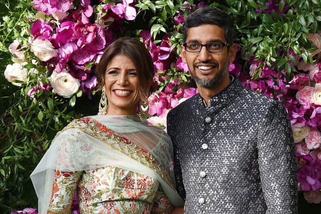 Indian businessman and Google CEO Sundar Pichai (R) poses for photographs with his wife and engineer Anjali Pichai as they arrive to attend the wedding ceremony of Akash Ambani (Credit: AFP via Getty Images)