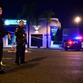 Police stand guard at the scene near the intersection of Garvey and Garfield Avenue in Monterey Park, California, after 10 people were killed in a shooting. (Photo by Frederic J. BROWN / AFP) (Photo by FREDERIC J. BROWN/AFP via Getty Images)