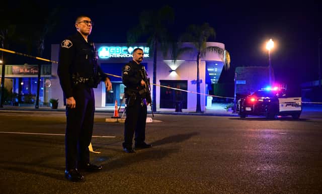Police stand guard at the scene near the intersection of Garvey and Garfield Avenue in Monterey Park, California, after 10 people were killed in a shooting. (Photo by Frederic J. BROWN / AFP) (Photo by FREDERIC J. BROWN/AFP via Getty Images)