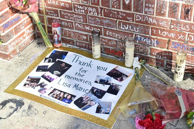 Candles are placed outside of Graceland as fans gather to pay their respects ahead of the public memorial for Lisa Marie Presley. (Photo by Justin Ford/Getty Images)