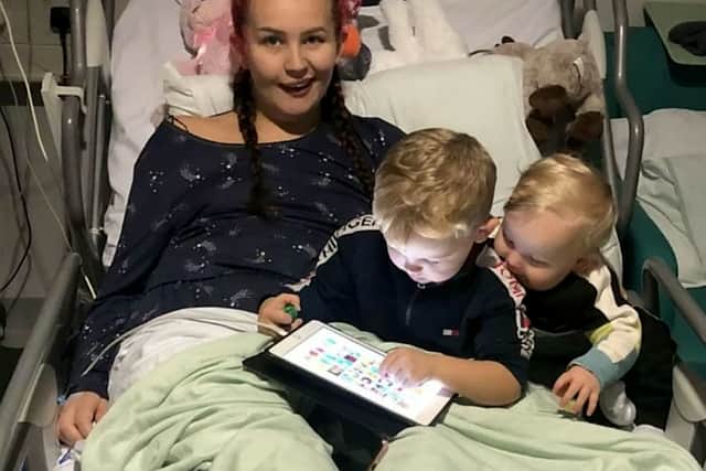 Casey Singleton, 22, who suffered an unexplained stroke on Nov 20 2022, pictured with her sons Tommy, 1, George, 3. Picture: SWNS