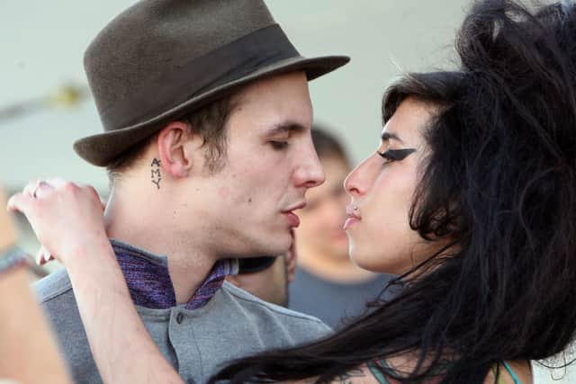 Singer Amy Winehouse kisses fiance Blake Fielder-Civil during day 1 of the Coachella Music Festival held at the Empire Polo Field on April 27, 2007 in Indio, California.  (Photo by Michael Buckner/Getty Images)