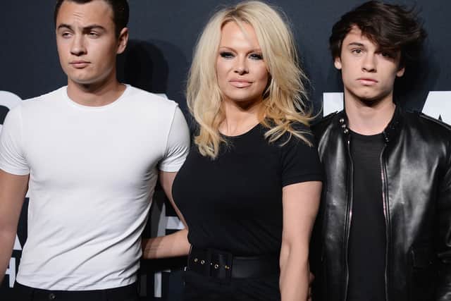 Actress Pamela Anderson (center) and her sons Brandon Lee (L) and Dylan Lee (Photo: Getty Images)