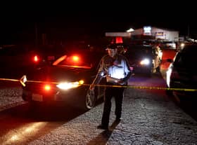 A San Mateo County sheriff deputy walks towards police tape as law enforcement officials conduct an investigation following a mass shooting on January 23, 2023 in Half Moon Bay, California