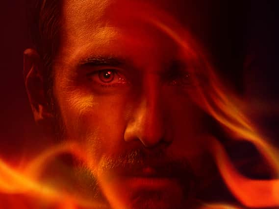 Rodrigo Santoro as Garrett Briggs in Wolf Pack, his face surrounded by flames (Credit: Paramount+)