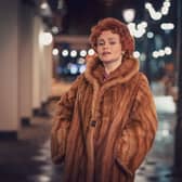 Helena Bonham Carter as Noele ‘Nolly’ Gordon in Nolly, wearing a fur coat at night (Credit: ITVX)