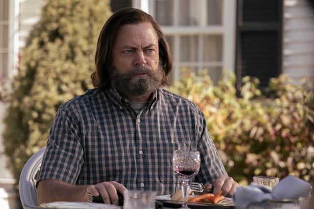 Nick Offerman as Bill in The Last of Us, drinking wine cautiously (Credit: HBO)