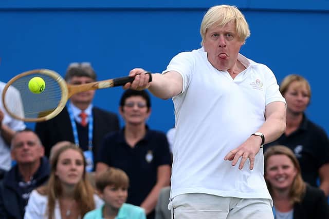 London Mayor Boris Johnson laughs in action during the Rally Against Cancer charity match on day seven of the AEGON Championships at Queens Club on June 16, 2013 in London, England. (Photo by Clive Brunskill/Getty Images)