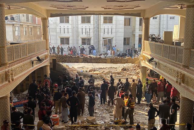 Security officials inspect the site of a mosque blast inside the police headquarters in Peshawar on January 30, 2023. - At least 17 people were killed in a mosque blast at a police headquarters in Pakistan, a hospital official said. 