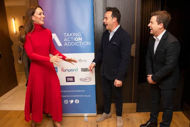 Kate Middleton in a red Ralph Lauren jumper and Christopher Kane dress with Ant and Dec. (Photo by PAUL GROVER/POOL/AFP via Getty Images)