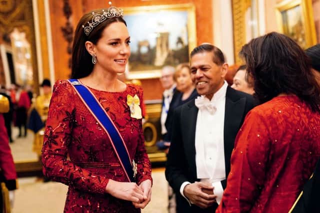 Kate Middleton wore a red Jenny Packham gown for the Diplomatic Reception at Buckingham Palace the same night Meghan Markle wore white. (Photo by VICTORIA JONES/POOL/AFP via Getty Images)